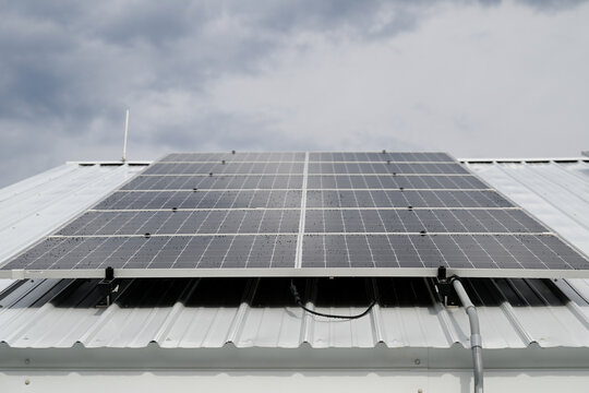 Solar Panels on Metal Roof Renewable Energy Installation with water on the panels