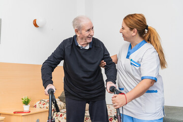 Caring nurse assisting elderly man in nursing home