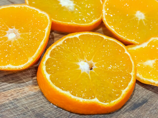 Freshly sliced oranges on a wooden cutting board showcasing vibrant colors and juicy texture