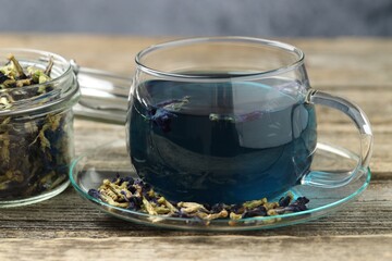 Delicious butterfly pea flower tea on wooden table, closeup
