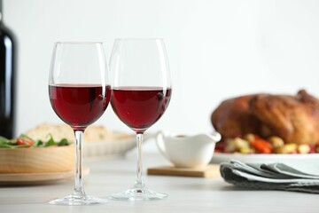 Red wine and delicious dinner served on light table