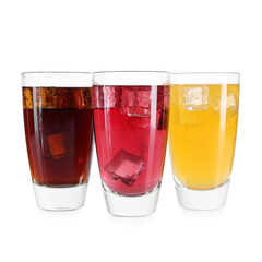 Soda water of different flavors with ice cubes in glasses isolated on white
