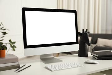 Fototapeta premium Modern workplace with computer and stationery on white desk indoors