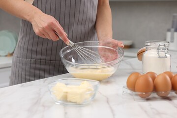 Woman making dough at white marble table indoors, closeup