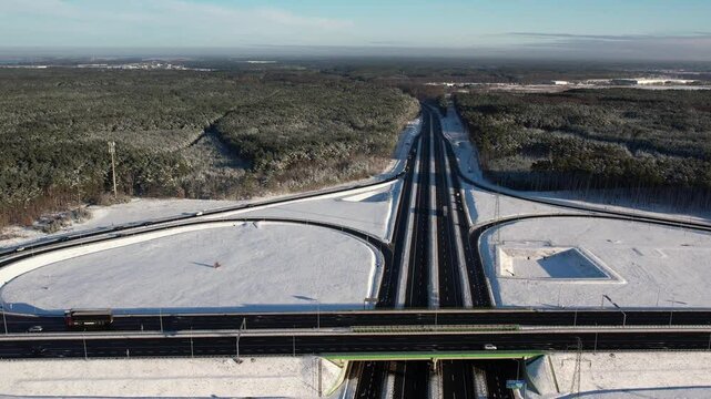 Aerial view of a road junction in a winter landscape. Motorway road junction.