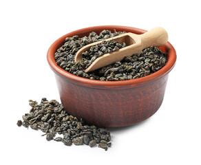 Dry tea leaves in bowl and scoop isolated on white