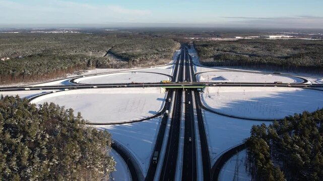 Aerial view of a road junction in a winter landscape. Motorway road junction.