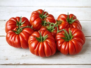 Fresh red tomatoes on a white table, ready for use in salads or other dishes.