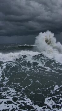 stormy sea waves, hurricane waves from safe distance, ominous storm light, awesome and humbling.

