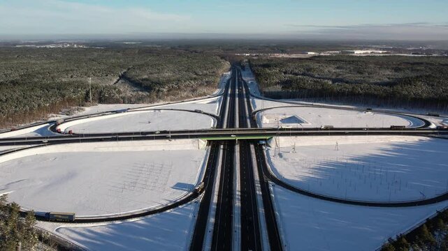 Aerial view of a road junction in a winter landscape. Motorway road junction.