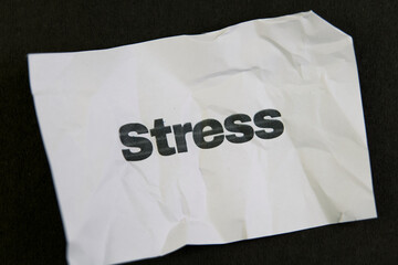 Crumpled paper with stress written on it signifies anxiety