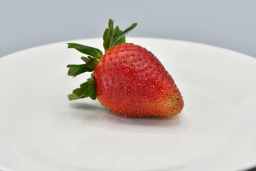 Close-Up of a Fresh Strawberry on a White Plate