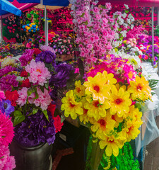 Vibrant flower market bursting with colors and textures under a lively canopy of umbrellas
