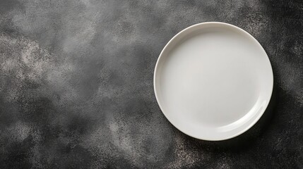 Elegant White Plate Resting on a Glossy Black Surface Showcasing a Minimalistic Yet Striking Contrast Highlighting the Beauty of Simple Dining Aesthetic and Modern Tableware Design