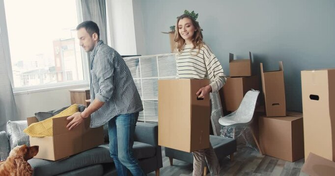 A couple happily moving into their new home filled with packed boxes and great excitement