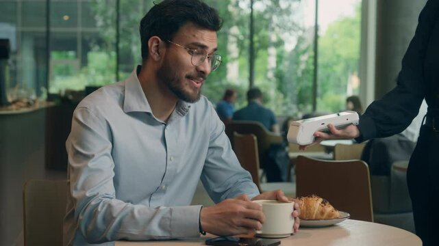 Indian business man guy male businessman visitor customer contactless NFC payment mobile phone buy purchase cafe order cashless service online bank wifi scan credit card smartphone terminal pay waiter