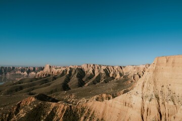 Rugged canyons under a vast blue sky.