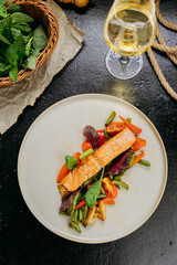 Grilled salmon fillet with fresh vegetables, served on a plate, elegant food presentation
