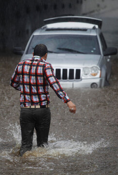 Driver gets stuck with his car in Marginal avenue during a big flood amid heavy rains in Sao Paulo, Brazil.