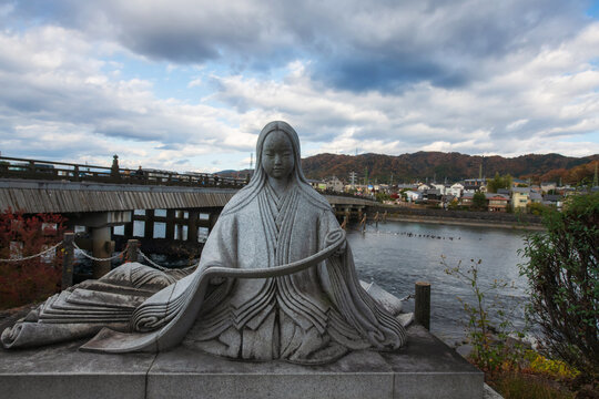 Murasaki Shikibu statue near Uji River in autumn, Kyoto, Japan
