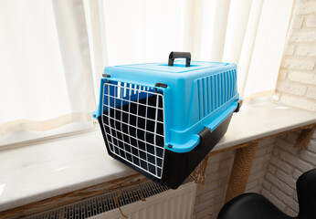 Plastic pet carrier, box with grid for cats or dogs.