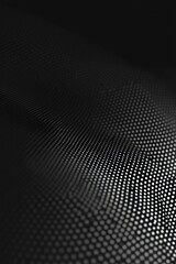 Obraz premium A black and white photo of a patterned fabric with a lot of dots. The image has a moody and abstract feel to it, with the dots creating a sense of depth and texture. The pattern is intricate
