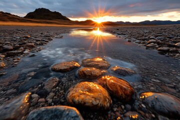Obraz premium Bright sunset casting reflections on tranquil stream with pebbles in serene landscape