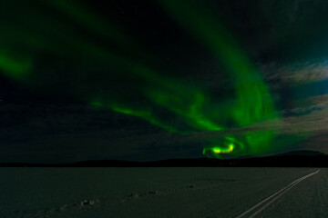 Aurora Borealis - Northern Lights - over frozen lake Akaslompolo in Finnish Lapland.