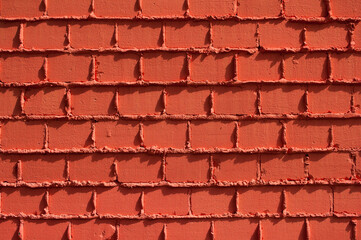 The photograph shows a close-up of an orange brick wall
