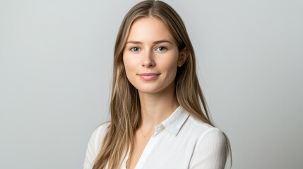 Obraz premium A woman with long brown hair and a white shirt is smiling for the camera
