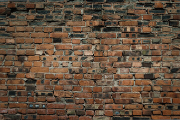 brick wall made of old bricks brown and black colors close up