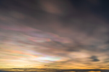 Beautiful winter sunset with rare nacreous clouds known as rainbow clouds in Finnish Lapland.