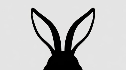 Silhouette of a rabbit's ears against a light background, symbolizing playfulness and cuteness.