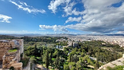 Obraz premium Ancient ruins, a park, and city houses. View from the hill. Greece, Athens