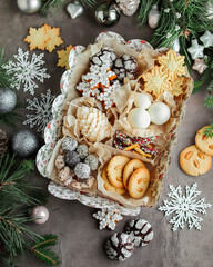 Box with New Year's sweets. Edible gift. Cookies, chocolate and marshmallows.
