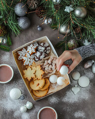 Box with New Year's sweets. Edible gift. Cookies, chocolate and marshmallows.