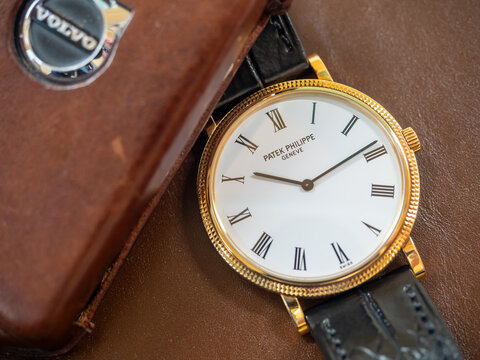 BANGKOK - JANUARY 30 : Patek Philippe Calatrava model 5120, 18k solid gold, white porcelain dial, roman marker, automatic, was taken on brown leather background in Bangkok, Thailand, January 30, 2025 