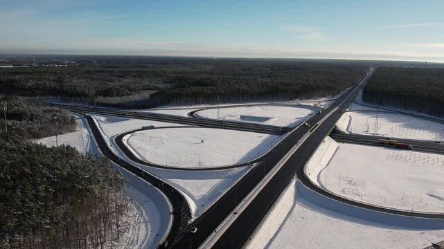Aerial view of a road junction in a winter landscape. Motorway road junction.