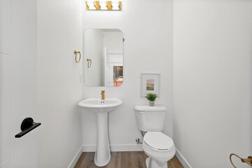 A bathroom with a white toilet and sink