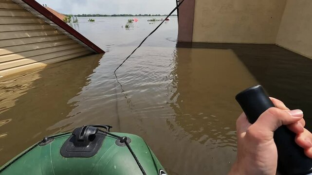 Male hands of volunteers rowing with an oar the boat after detonation of Hydroelectric Power Station. Flooding in Kherson as result of explosion of dam on Dnipro river in city of Novaya Kakhovka