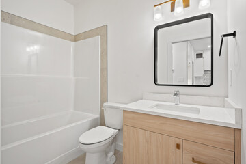A bathroom with a white toilet and a white sink