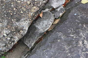 A huge crack in a stone wall.