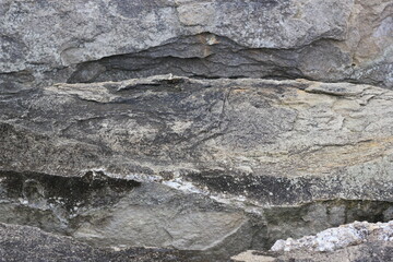 A huge crack in a stone wall.