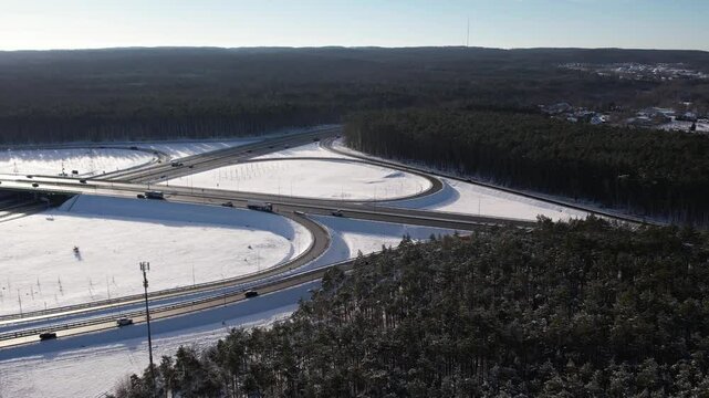 Aerial view of a road junction in a winter landscape. Motorway road junction.