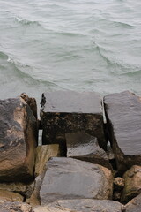 rocks on the beach set among the choppy waves