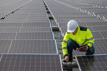 Engineer working at floating solar farm,checking and maintenance with solar batteries near solar...