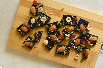 black chocolate bar with nuts and candied fruits