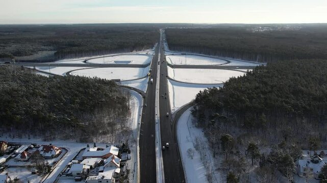 Aerial view of a road junction in a winter landscape. Motorway road junction.