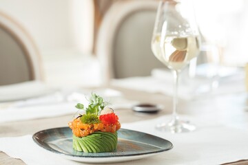A beautifully crafted sushi dish showcases vibrant flavors and fresh ingredients, complemented by a...