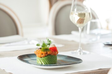 Savor a beautifully presented sushi creation featuring vibrant fish and fresh garnishes, paired...